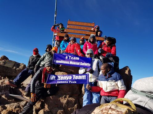 Expeditions Maasai Safaris customers pose for a photo at the Lenana Peak after a successful summit