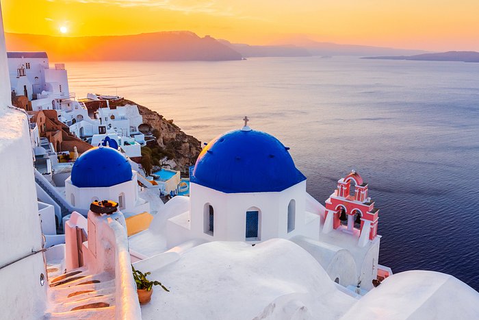 A picturesque view of the sun setting over Santorini, Greece