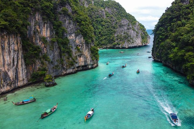 In this exciting trip, you will get to tour Phi Phi Island by a long boat as seen in the photo
