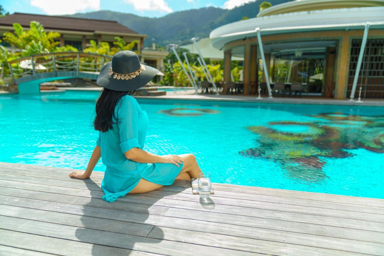 A woman enjoying a dip in the pool at Savoy Resort in Seychelles